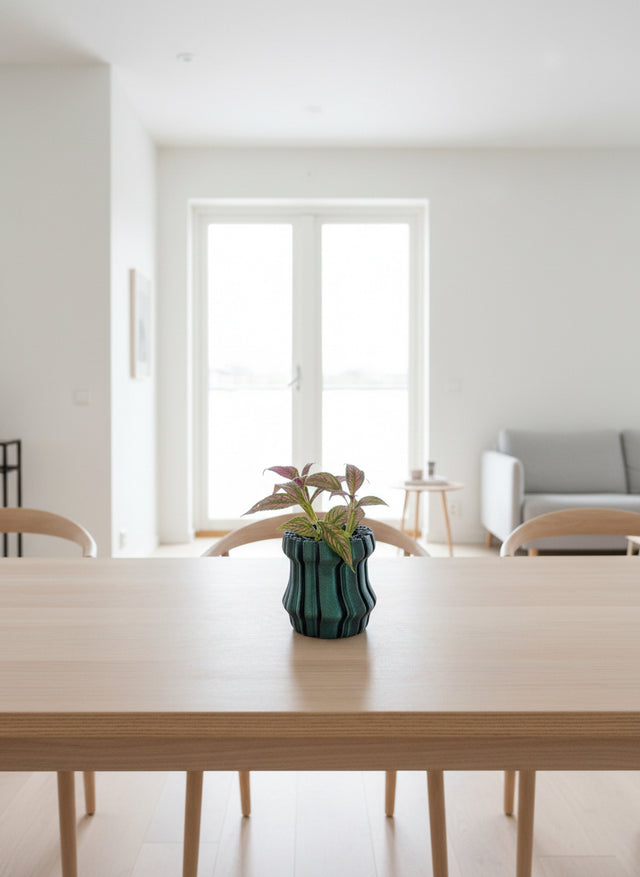 Modern interior with a wooden table, vase with plant, and white walls.